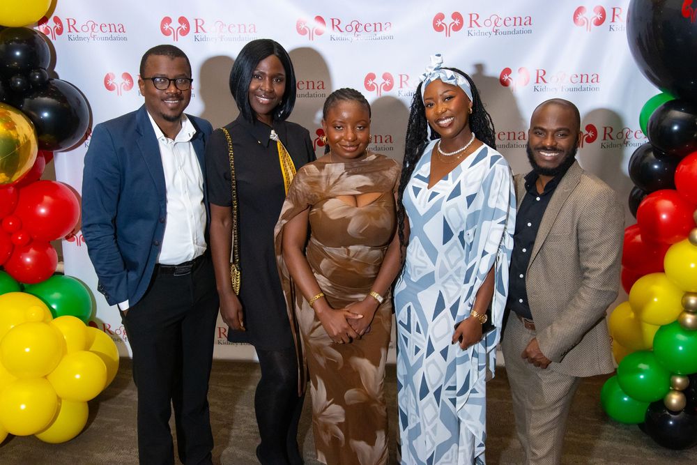 Five professionals pose together at a Rozena event with colorful balloons and branded backdrop.