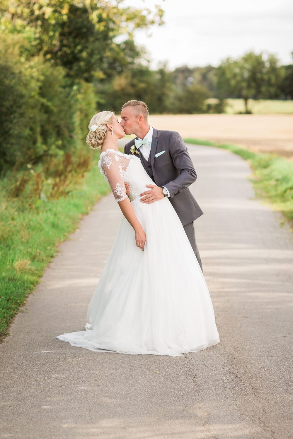 Brudepar omfavner hinanden på en landevej – bryllupsfoto af Martin & Louise
