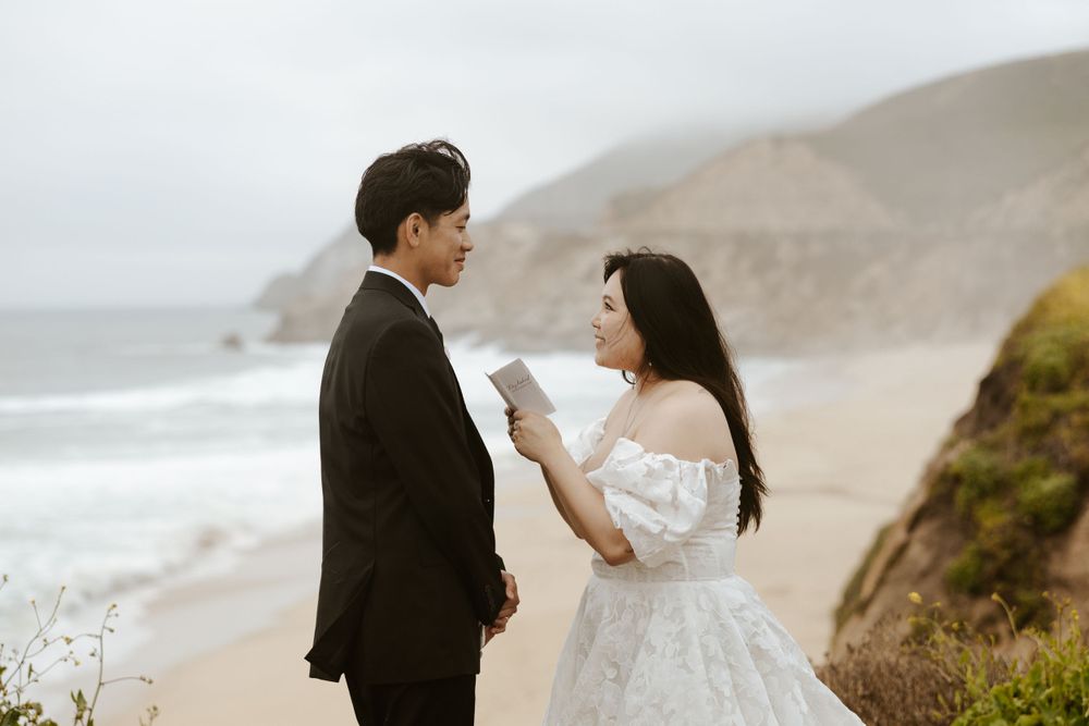 candid photo of bride sharing vows with groom on a cliff side on pacifica during their san francisco elopement day