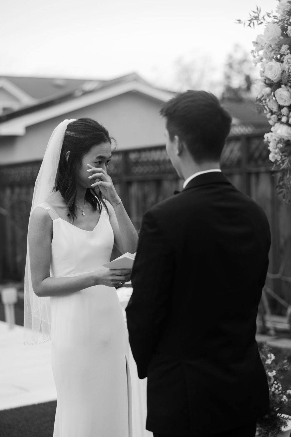 black and white photos of bride wiping tears away while sharing vows during wedding ceremony on their bay area elopement day