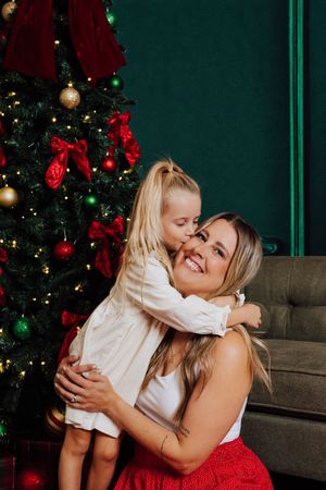 Mother hugging her two daughters during a Christmas mini session.