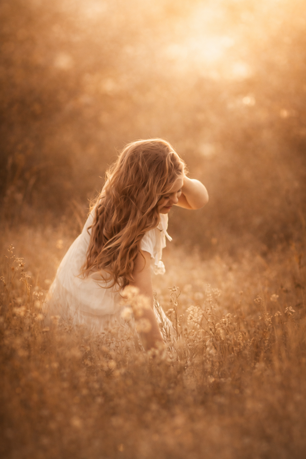 Girl standing in golden evening light in a South Jersey wildflower field during a portrait session.