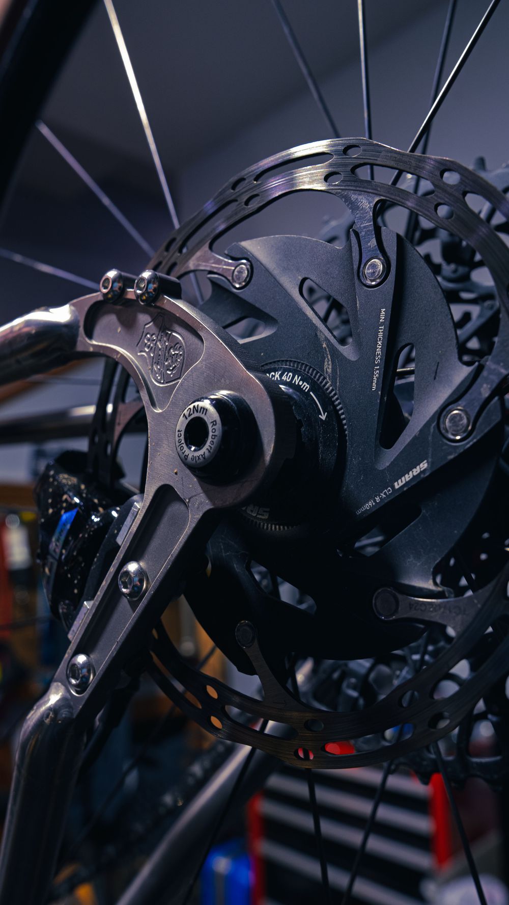 Detail of a SRAM disc brake rotor, thru-axle and hub on a mountain bike build at Velocity Multi Sport & Cycling.