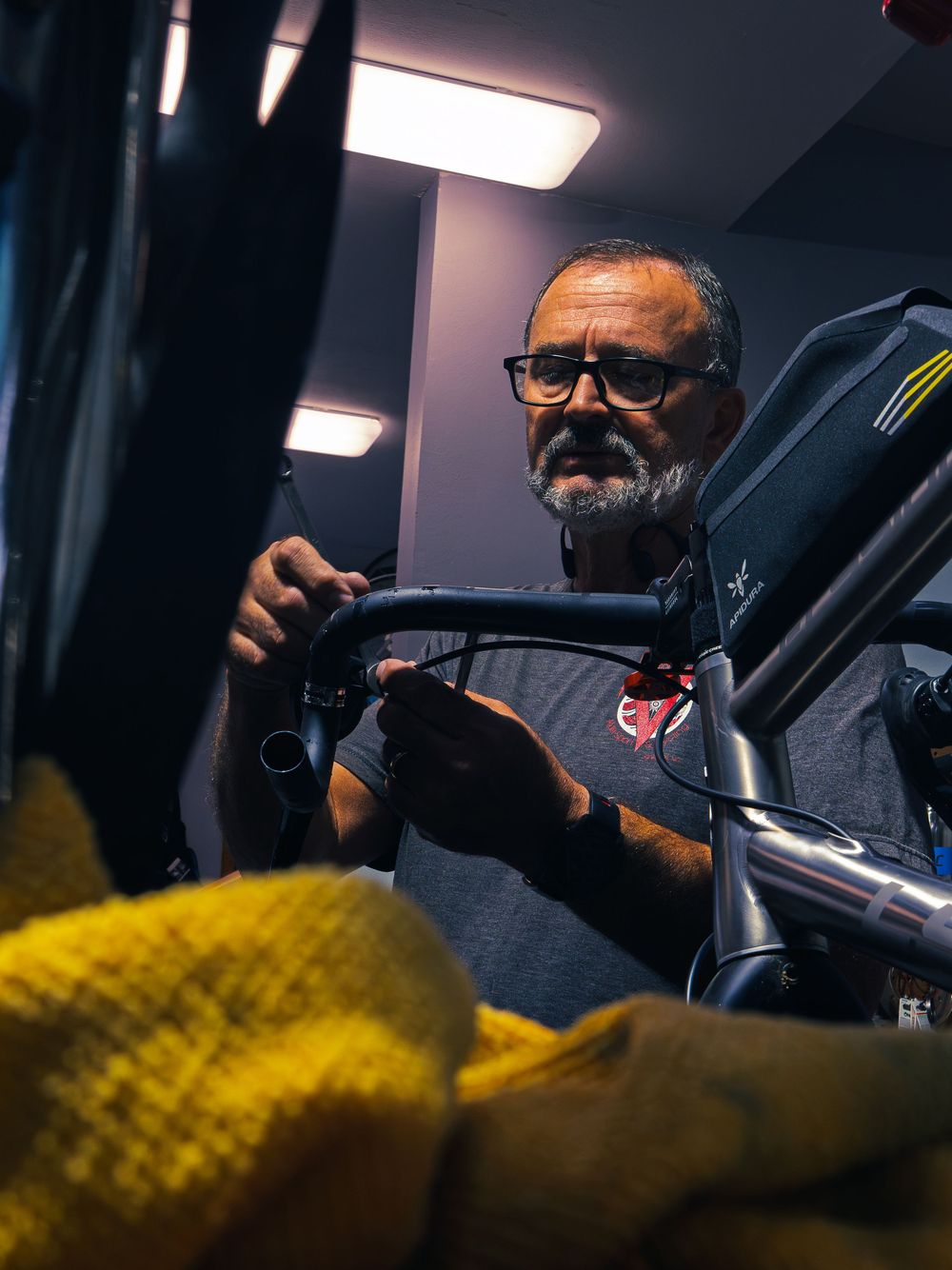 The focused owner of Velocity Multi Sport & Cycling working on a bike's handlebars in his Janesville shop.