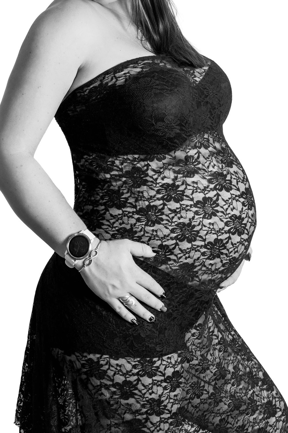 mother wearing a lace fitted dressing in her maternity session