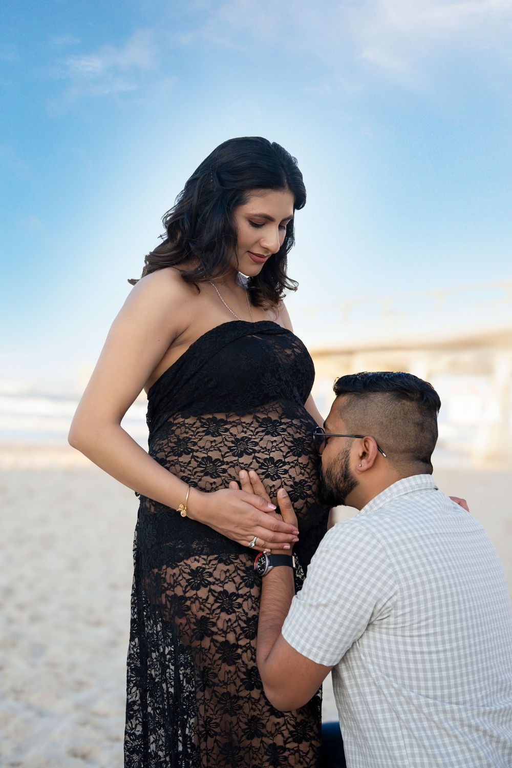 a couple celebrating their pregnancy with a maternity session at the spit Gold Coast