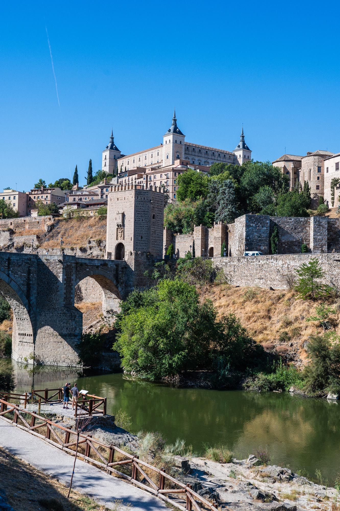 The Alcazar of Toledo and Puente de Alcantara bridge over the Tagus River in Toledo, Spain.