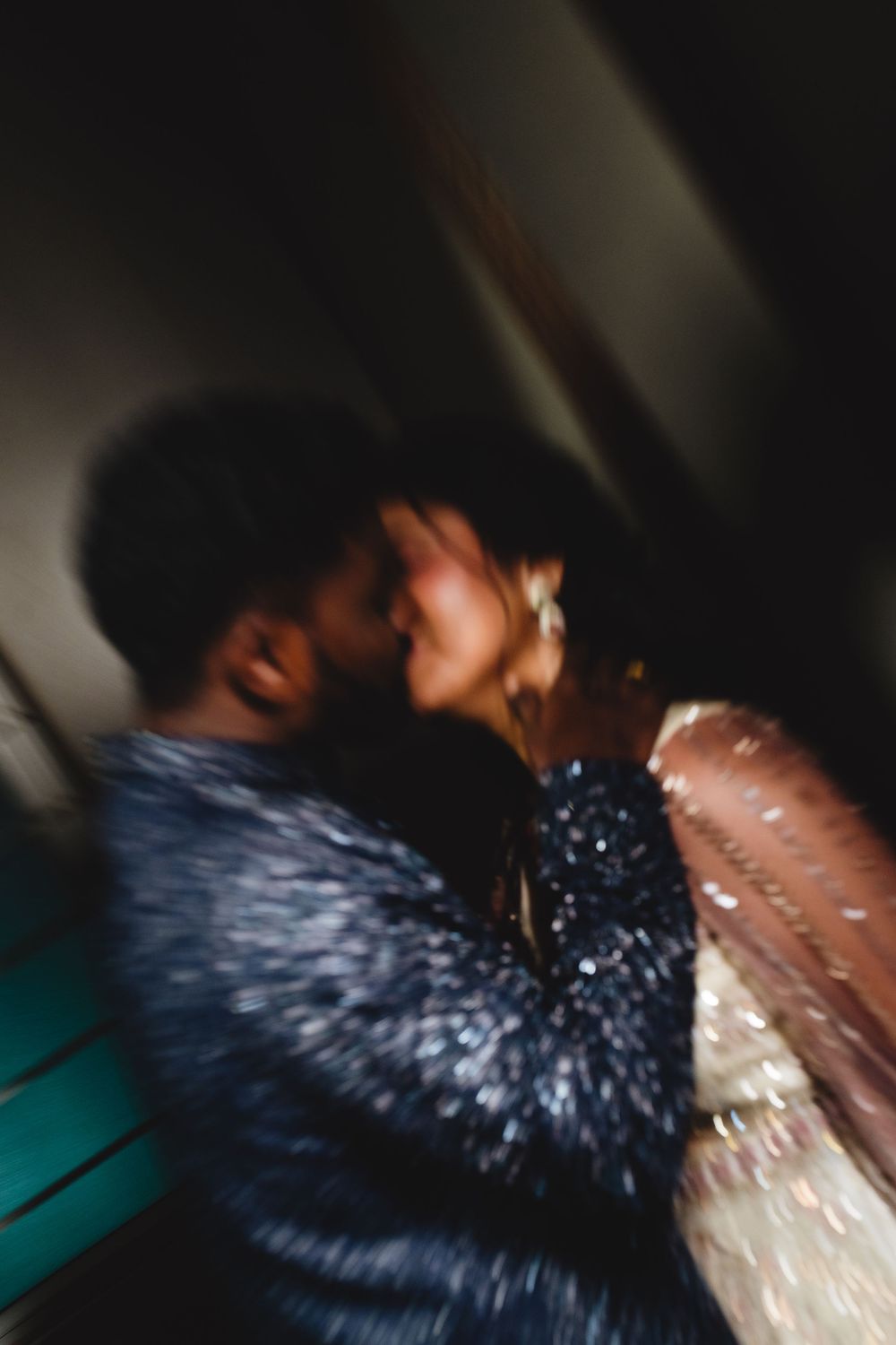 Blurred motion shot of an Indian couple in traditional attire sharing an intimate moment.