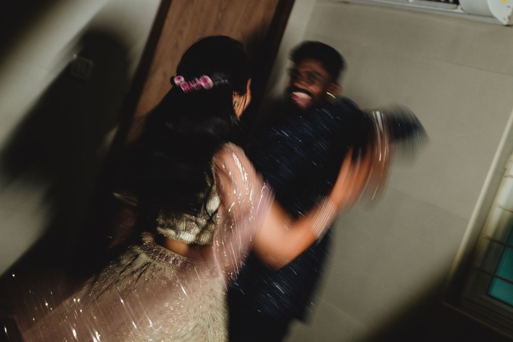 Two people dancing together at a party, captured with motion blur effect in dim lighting.