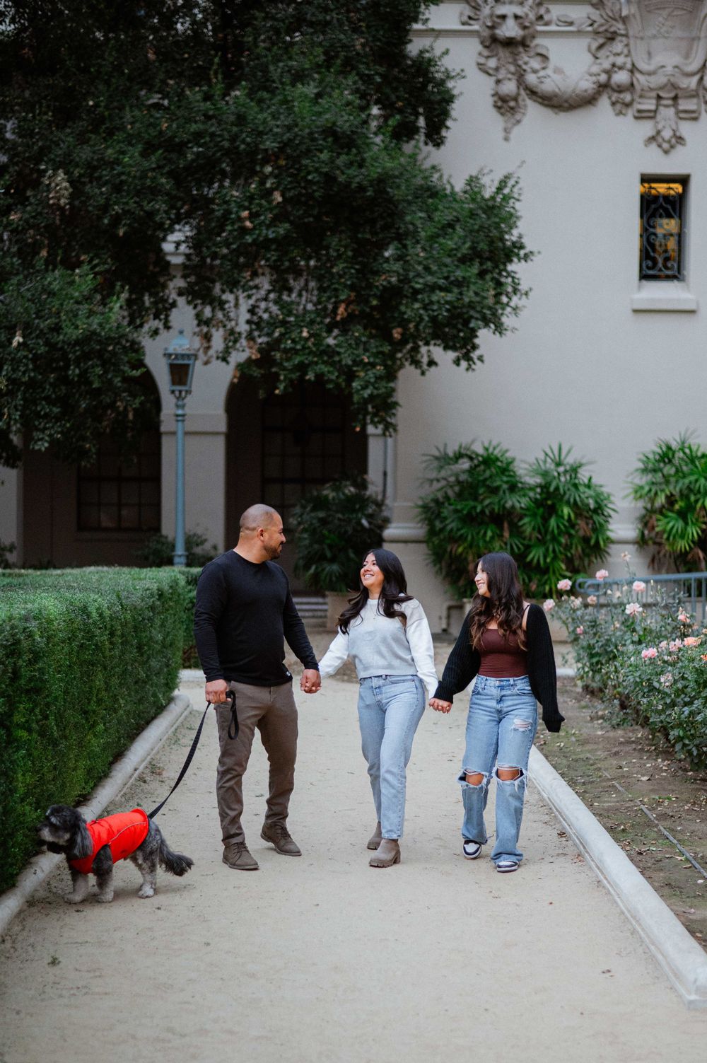 Group walking together on a stone path beside a white building.