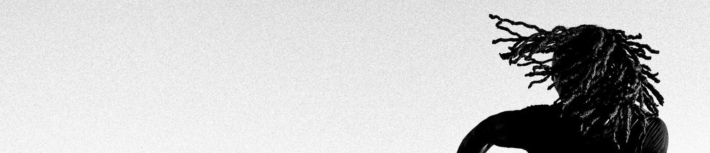 A minimalist black and white silhouette of a person with long dreadlocks against a light gray background.