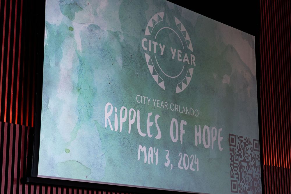 City Year Orlando Ripples of Hope event screen display dated May 3, 2024, featuring logo on green watercolor background.