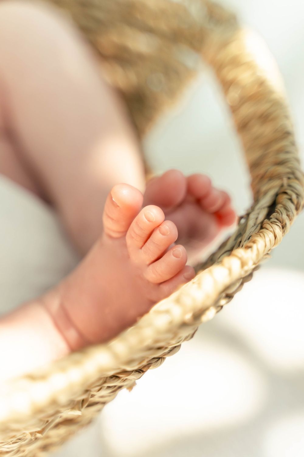 Newborn detail photo, baby feet in a basket