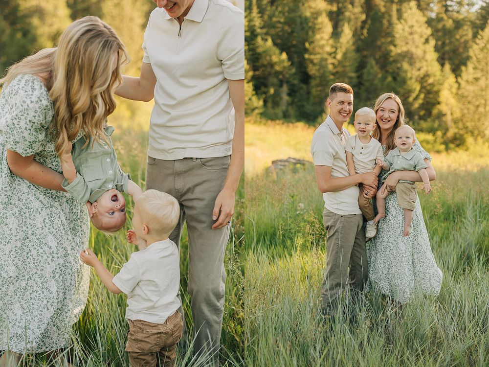 Family of four poses in a sunlit meadow with tall green grass and pine trees in the background.