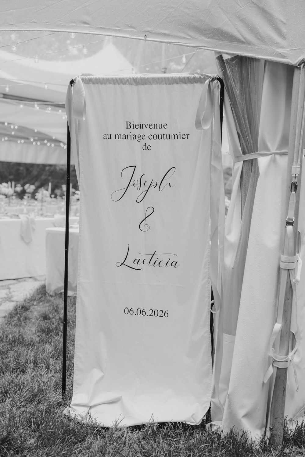 Black and white wedding welcome sign for Joseph and Laeticia's customary marriage on 06.06.2026.