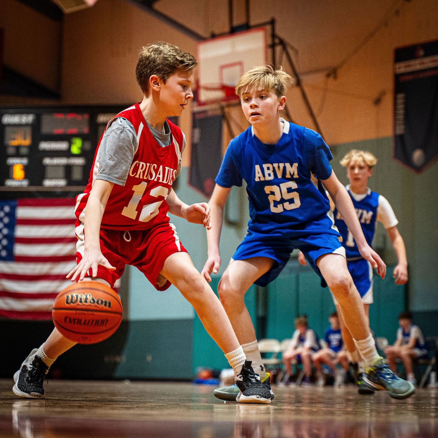 Youth basketball players on the court.