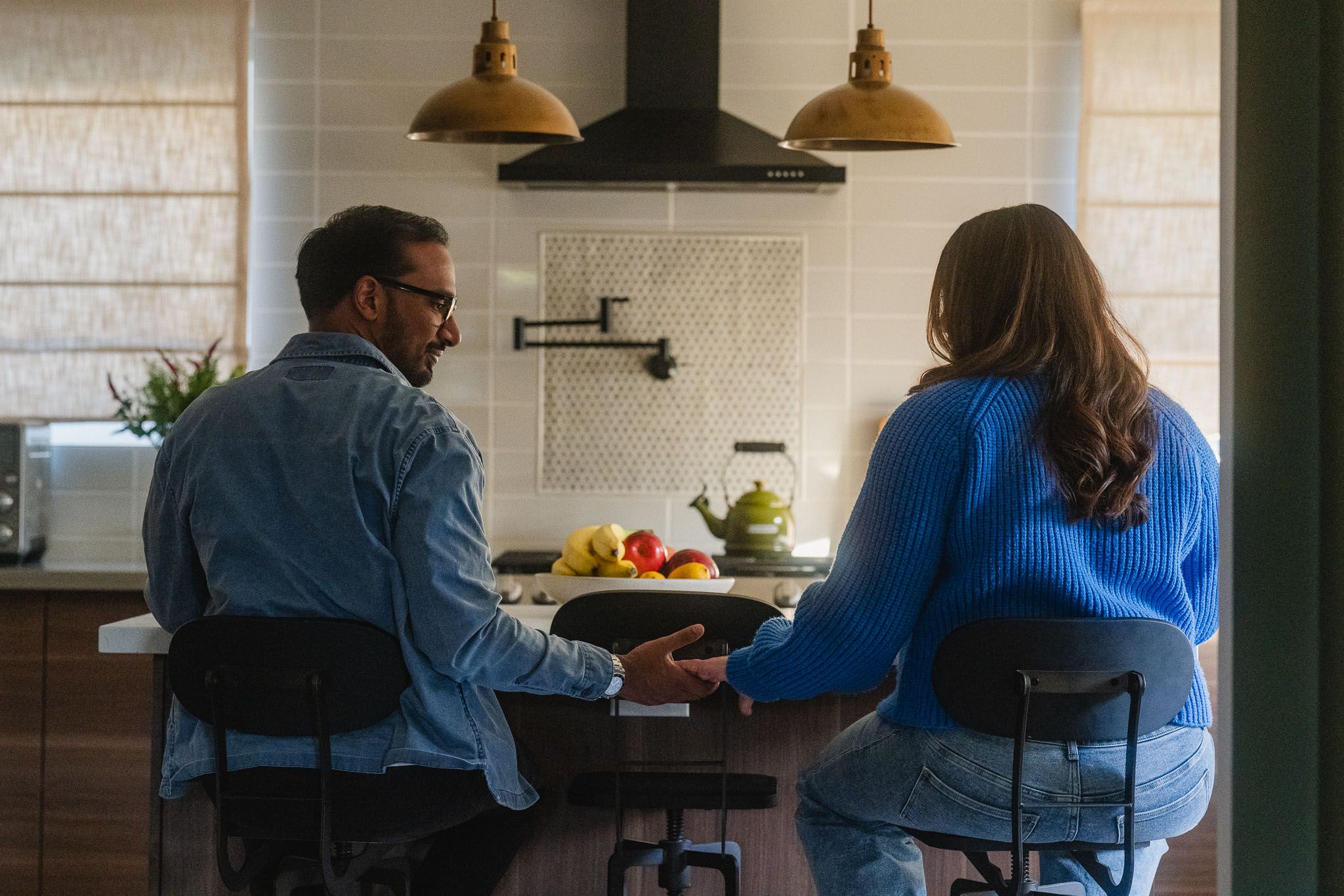 Rohan reaching for Amanda’s hand during their relaxed at home maternity photoshoot in Pasadena