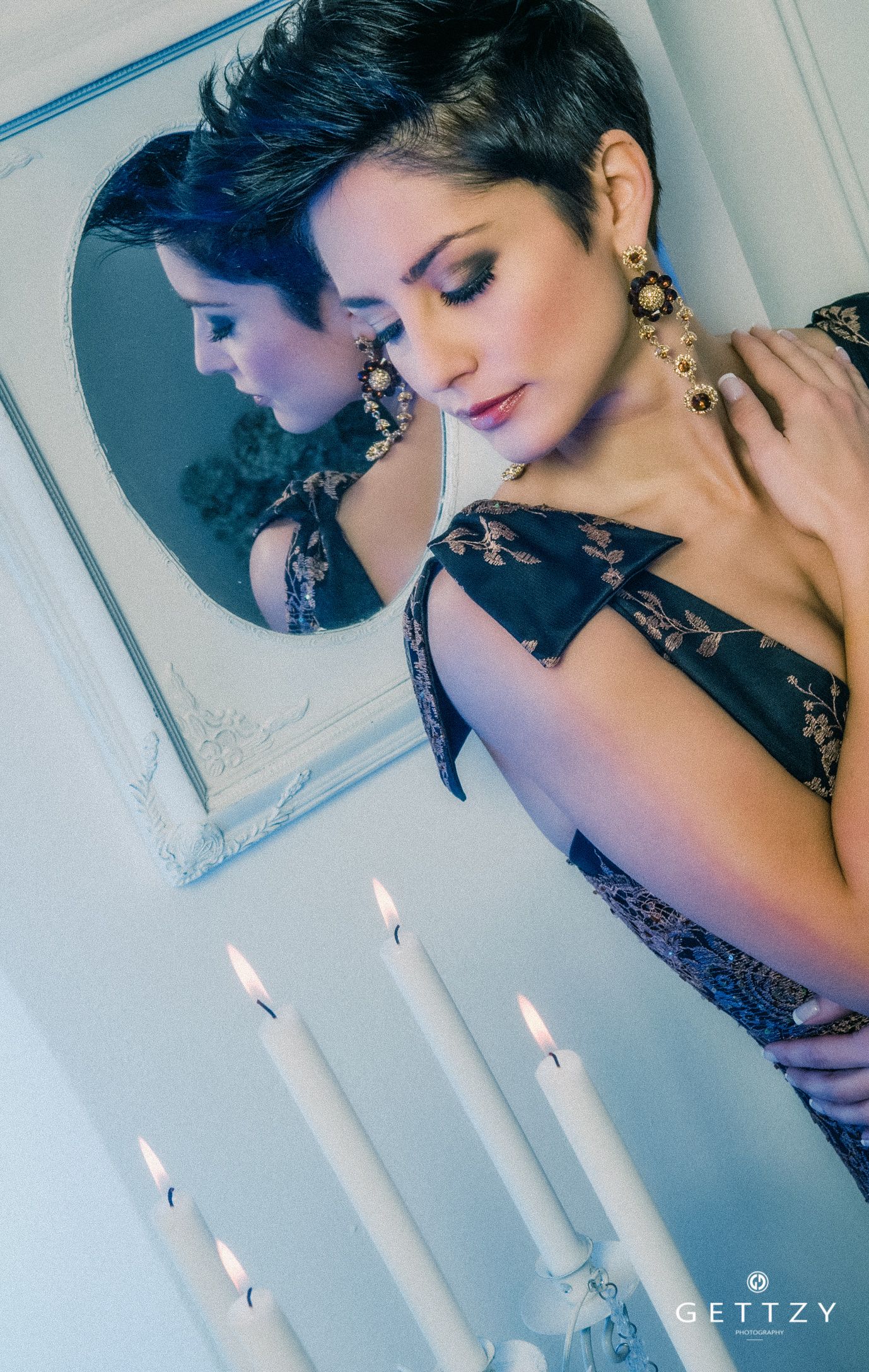 Romantic portrait Antonia Stupar Jurkin with mirror reflection, lace dress and lit candles creating ethereal atmosphere.