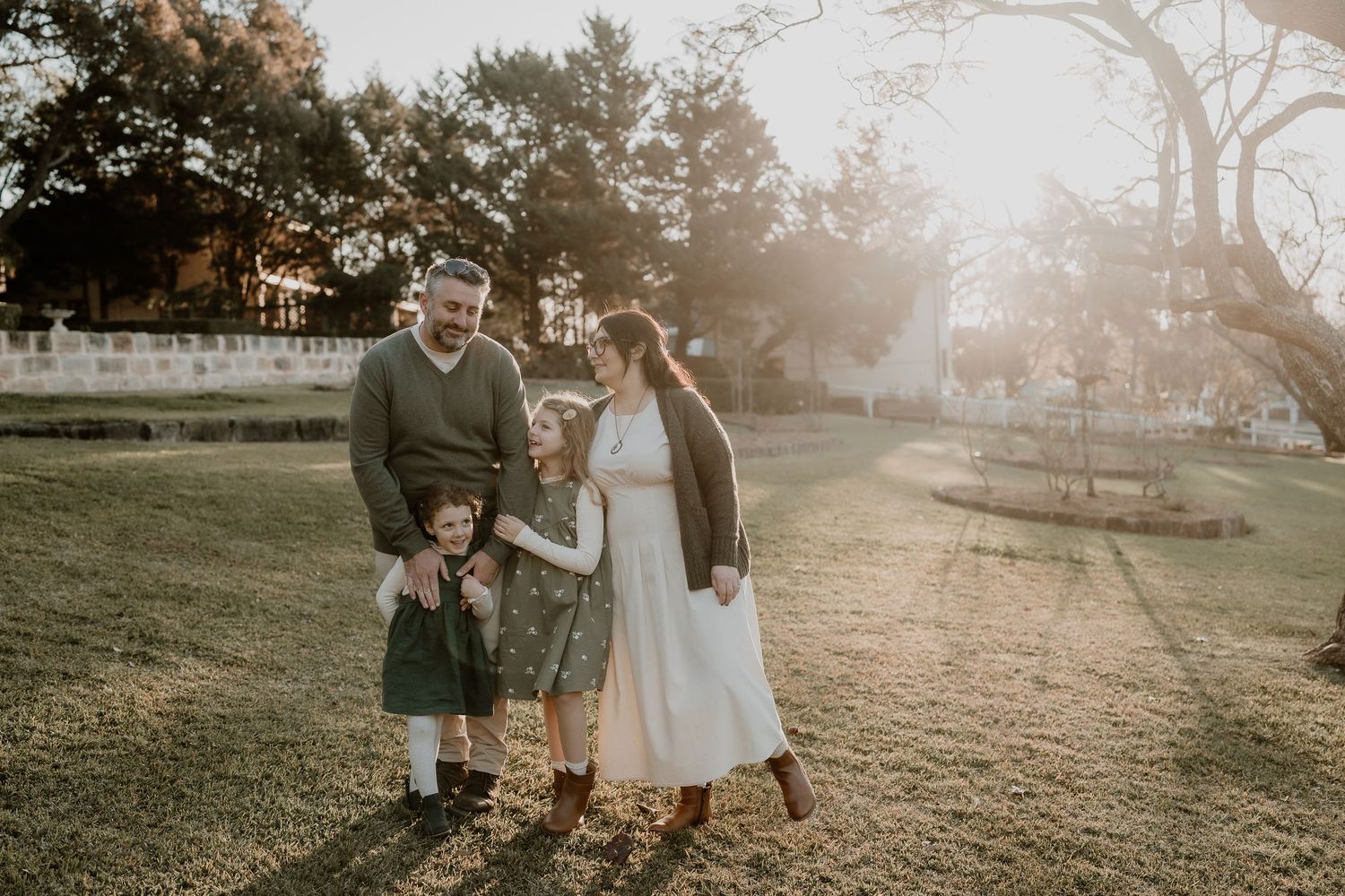 family with young children dressed in green in a park in Camden NSW