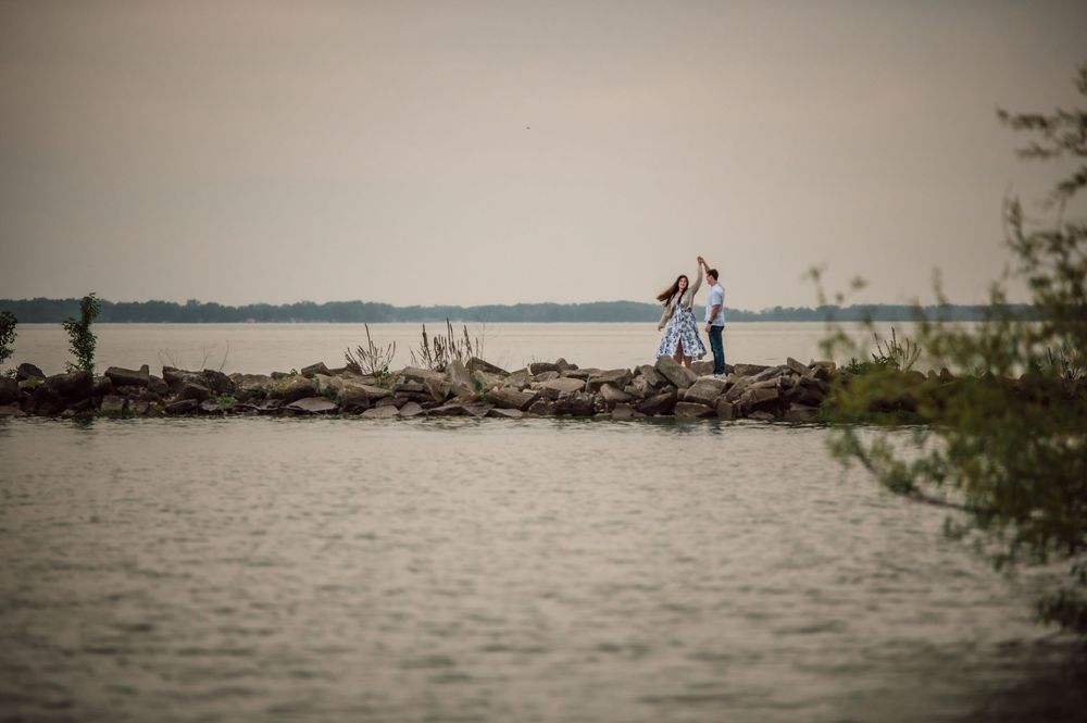 Engaged couple walking together during an outdoor engagement session in West Central Ohio