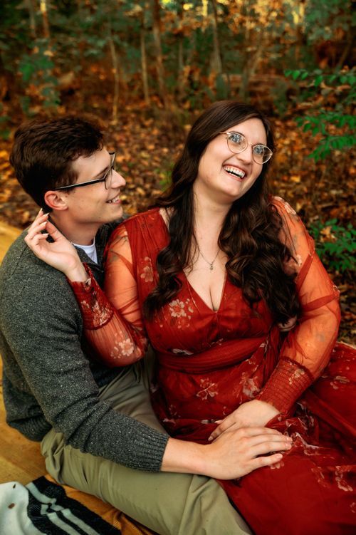Engaged couple laughing together during a natural outdoor engagement session in Ohio