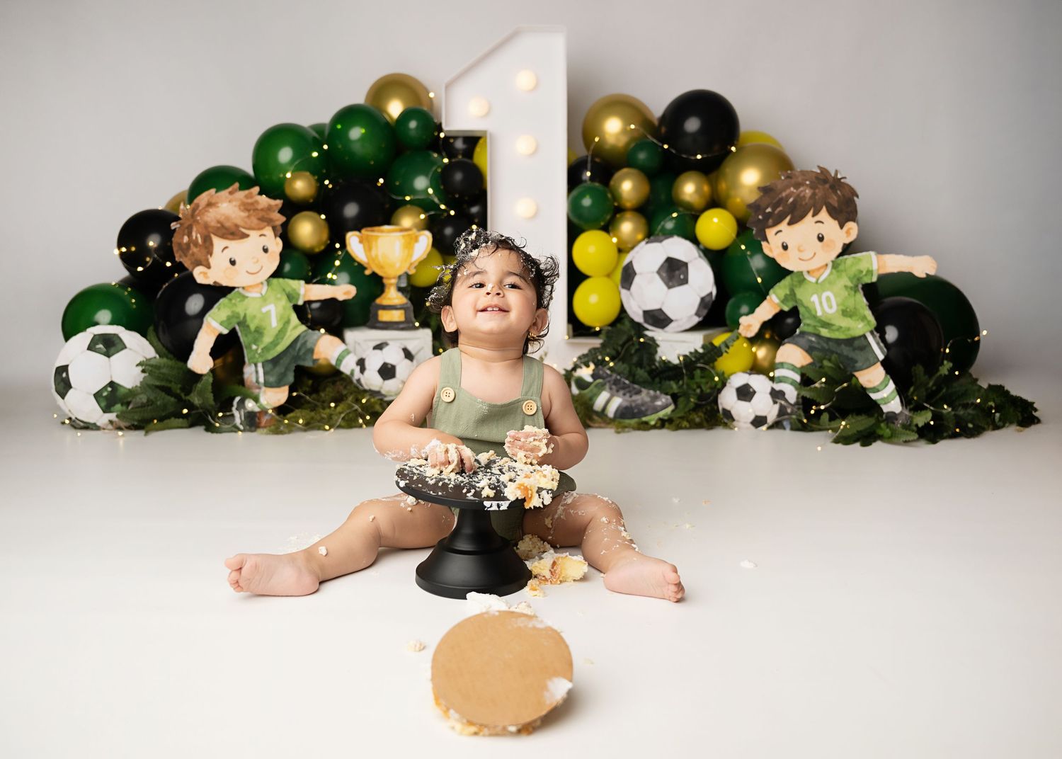 Baby celebrating a first birthday during a custom cake smash photography session in Linden, New Jersey.