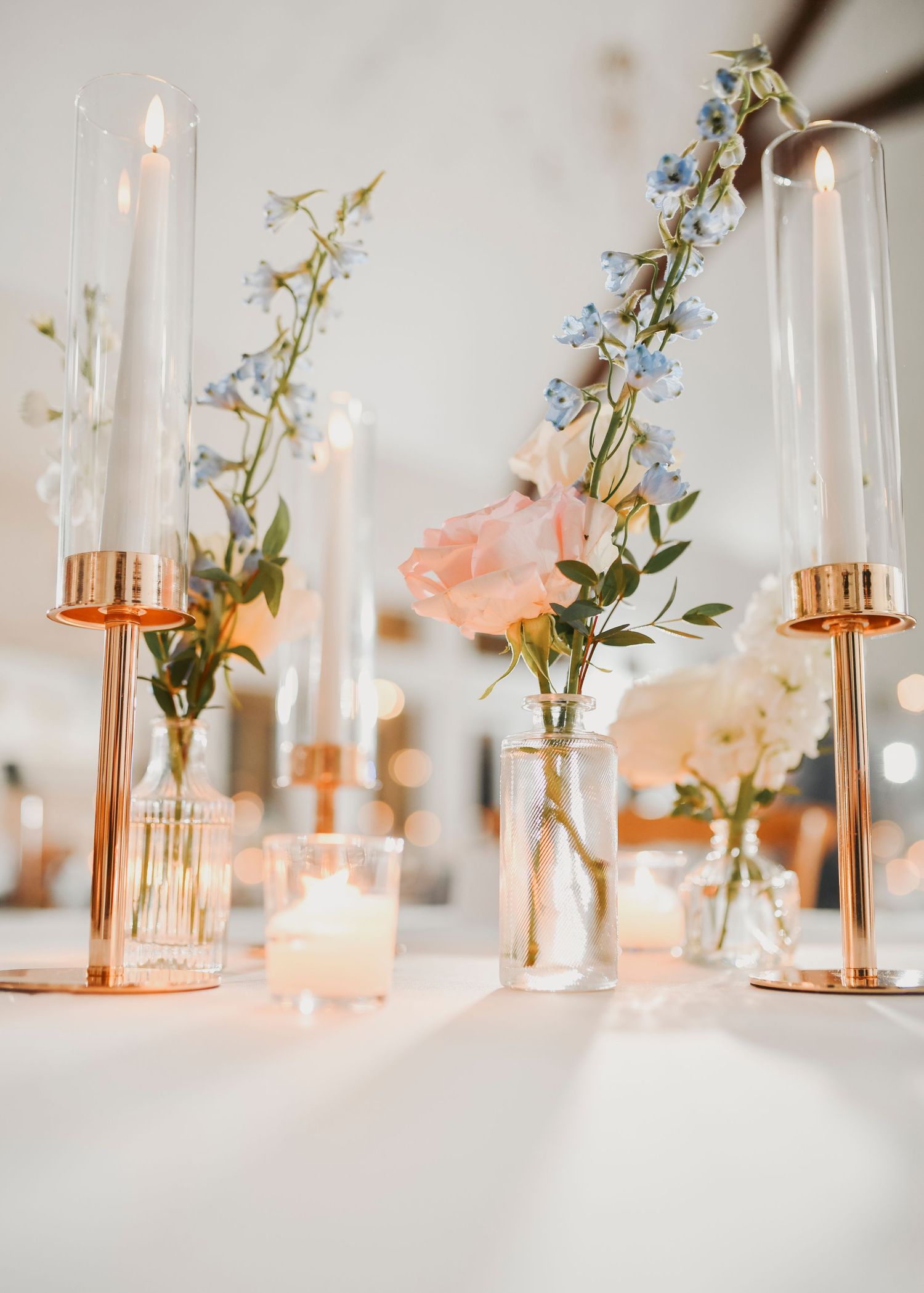 French Farmhouse wedding reception decorated with romantic candles and pastel florals