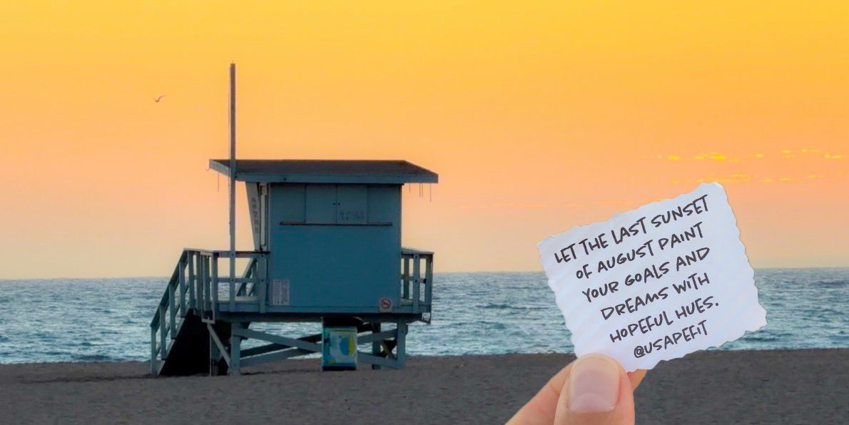 Hand holding a note card with inspirational quote at sunset beach with blue lifeguard tower in background.