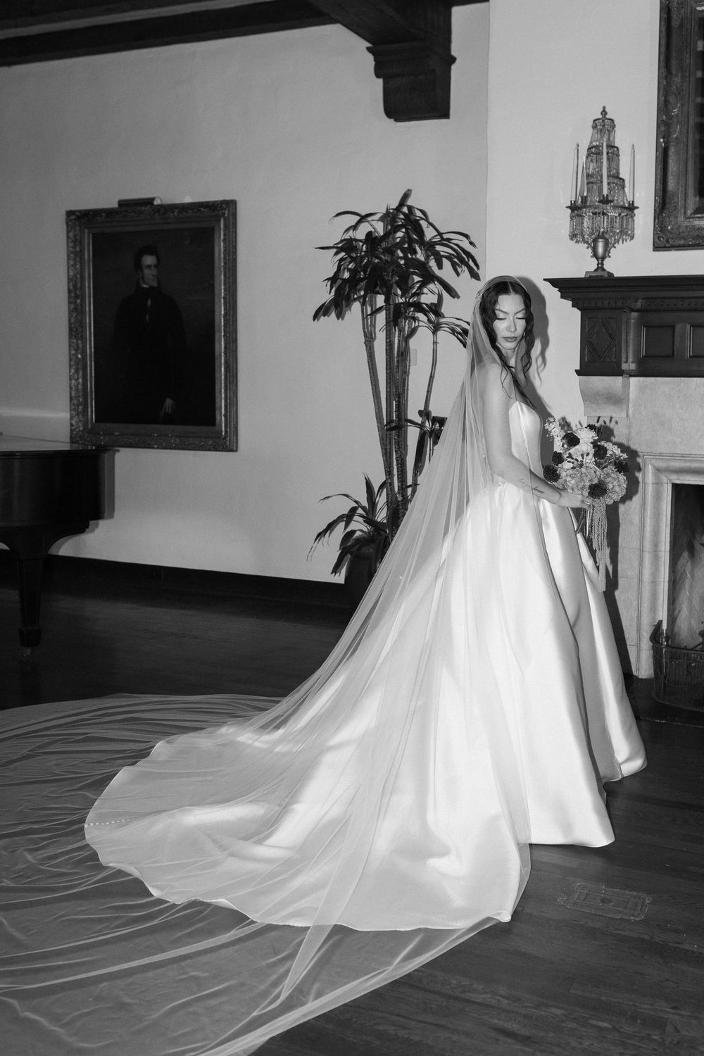 A high end editorial black and white photo of a bride in cathedral veil in an upscale wedding venue in Santa Barbara.