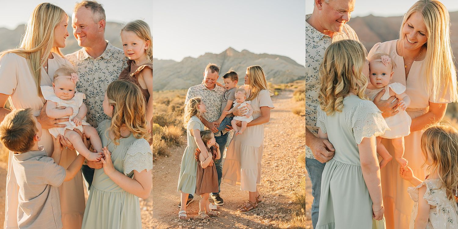 Family portrait session in desert landscape with mountains, parents and children in soft neutral tones during golden hour.