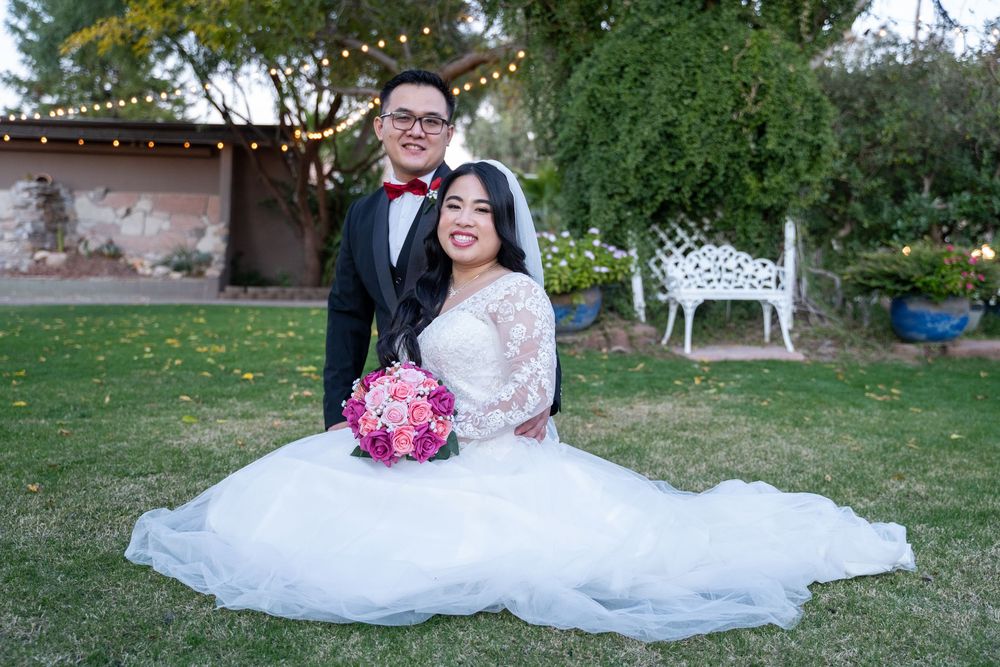 Relaxed wedding portrait of bride and groom sitting on the lawn at The Buttes at Reflections, photographed by N&D Media Production.