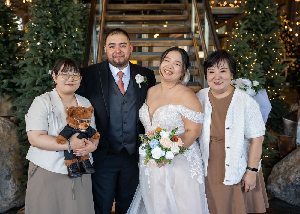 Touching family portrait with a memorial teddy bear honoring bride's late father at The Hitching Post, by N&D Media Production.