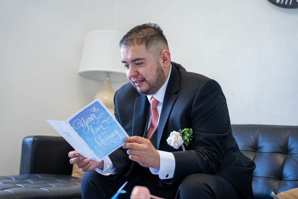 Emotional portrait of groom reading a note from the bride before their wedding at The Hitching Post, captured by N&D Media Production.
