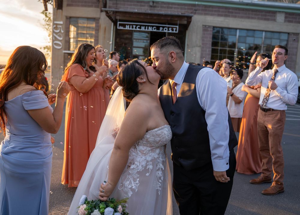 Golden hour send-off kiss as bride and groom exit their venue at The Hitching Post in Utah, photographed by N&D Media Production.