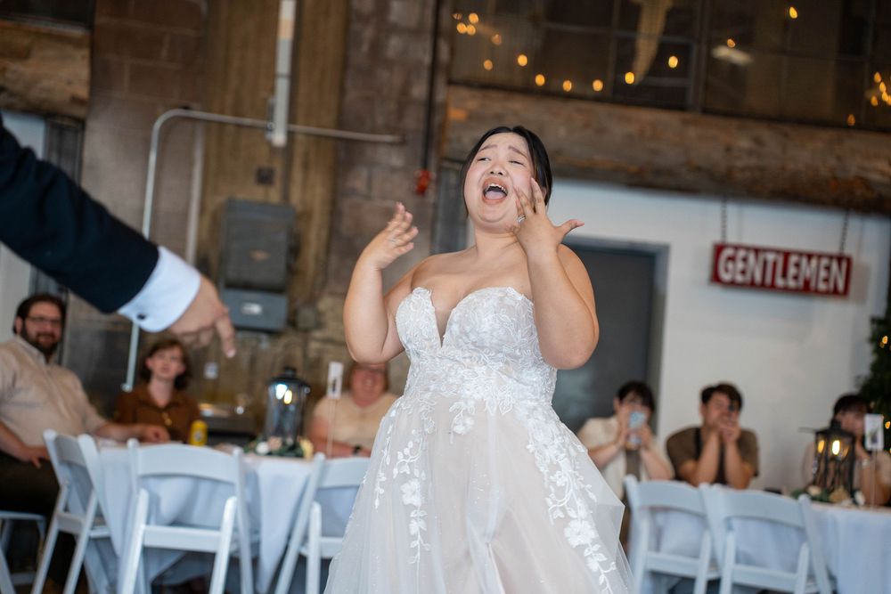 Joyful bride sharing a tender first dance with groom at The Hitching Post venue in Utah, photographed by N&D Media Production.