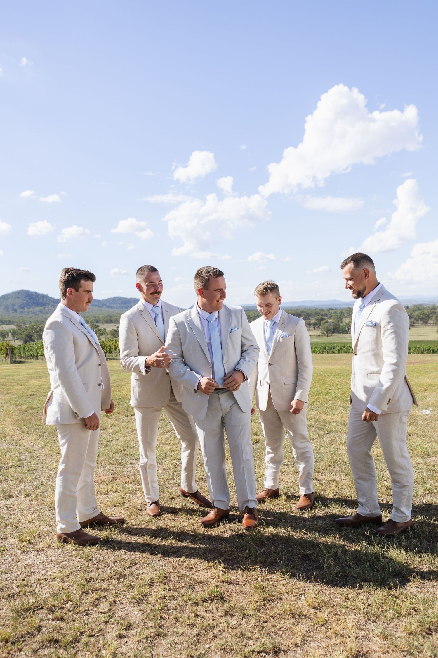 Groomsmen and groom laughing at Two Rivers Winery Wedding at Denman