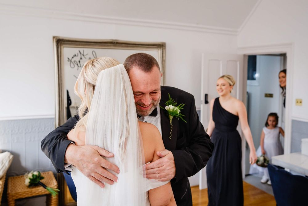 dad cuddles bride at a wedding in Kent