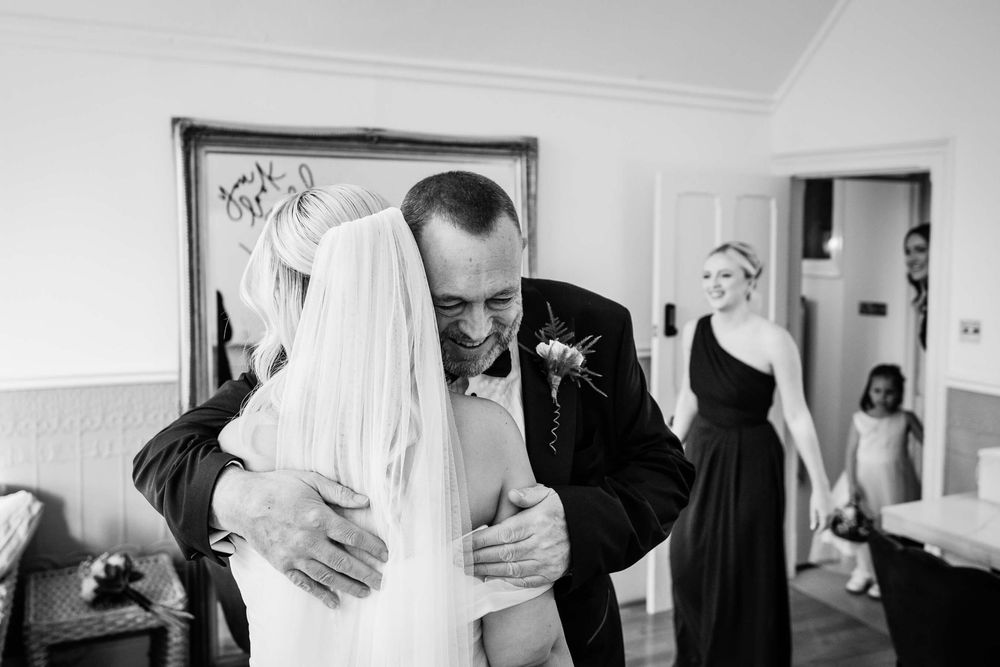 blackened white photos of bride cuddling her dad