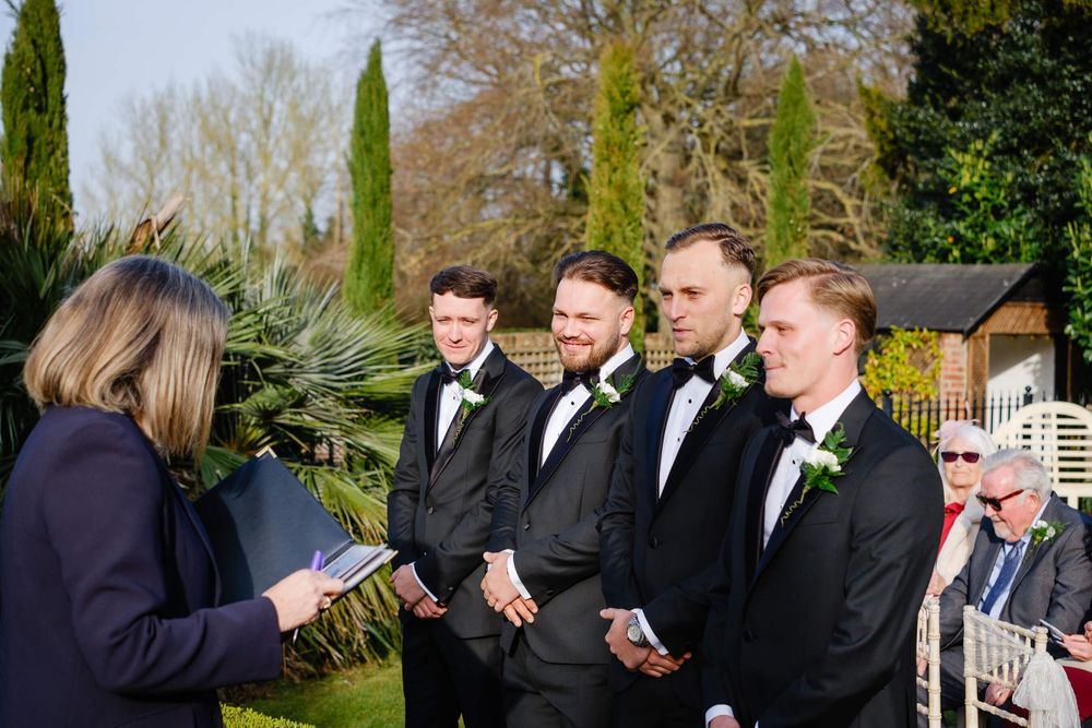 groom waits for the bride at the top of the aisle at Knowle country house