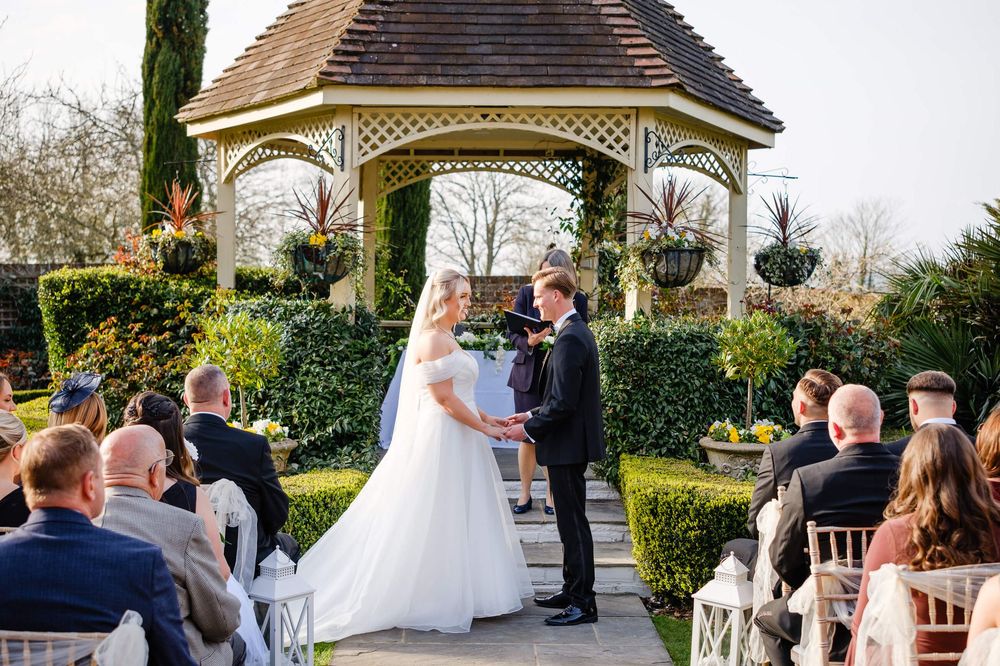 bride and groom at wedding in Kent under a gazebo