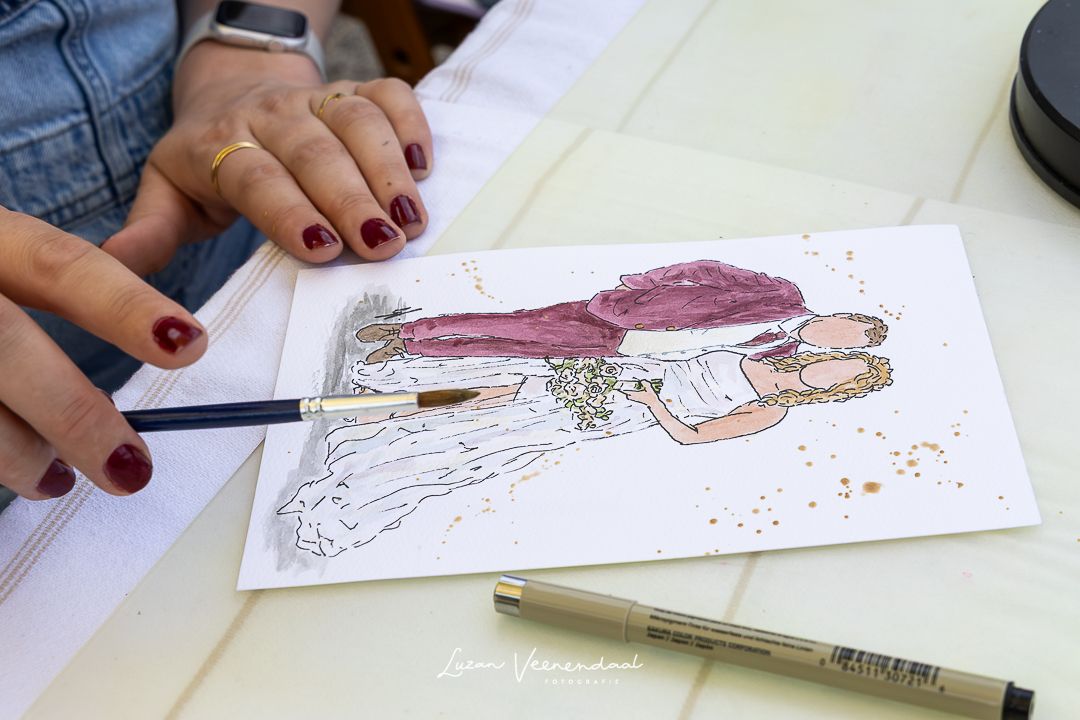 "Aquarel van Vincent en Madelief, live geschilderd tijdens de ceremonie in de tuin