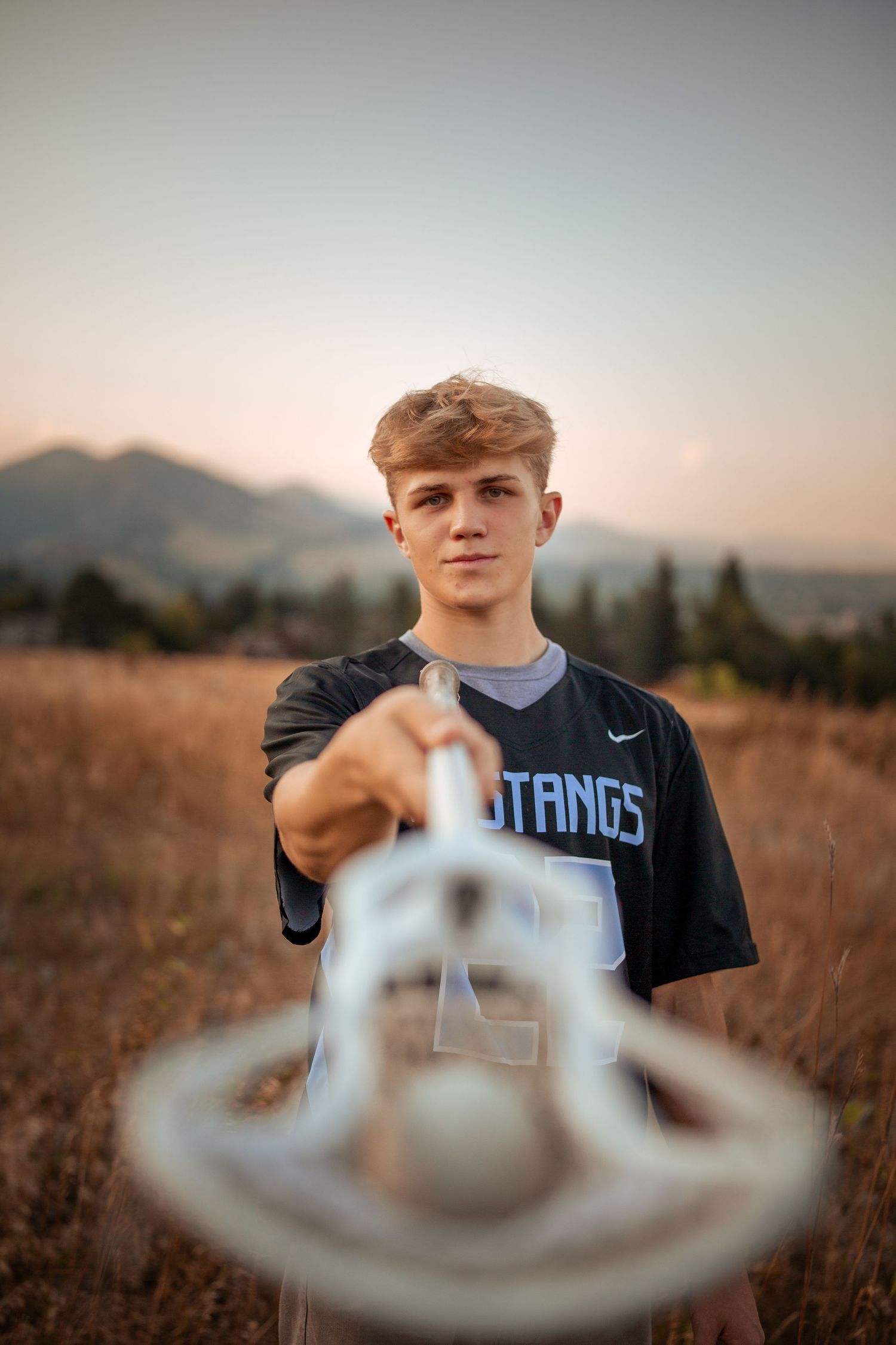 Creative photo of a sports jersey seen through blurred foreground elements at sunset.