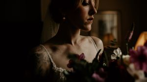 Intimate wedding portrait with moody lighting and dramatic shadows.