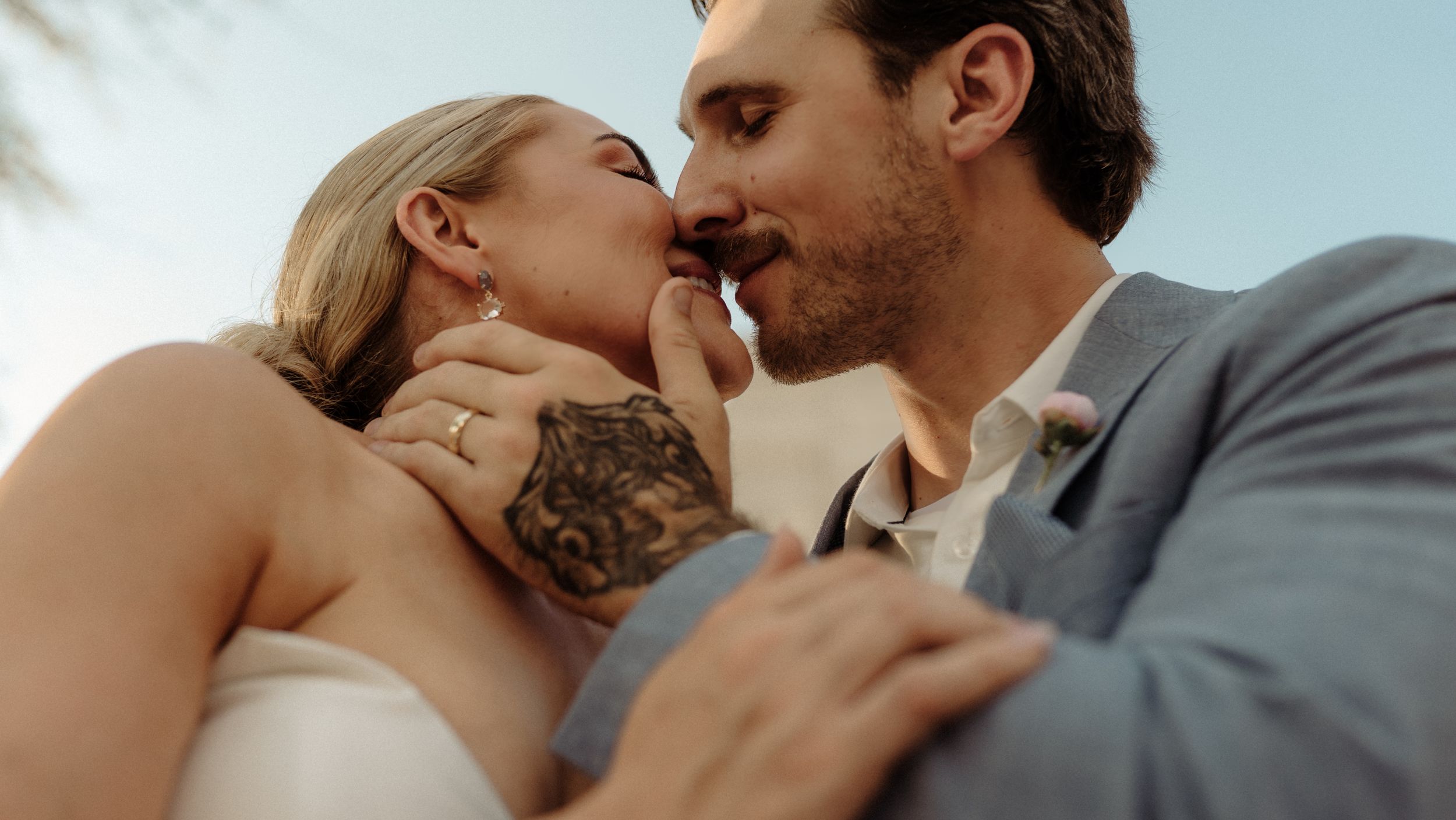 Intimate close-up of a romantic moment between a couple in wedding attire.
