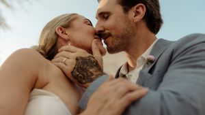 Intimate close-up of a romantic moment between a couple in wedding attire.