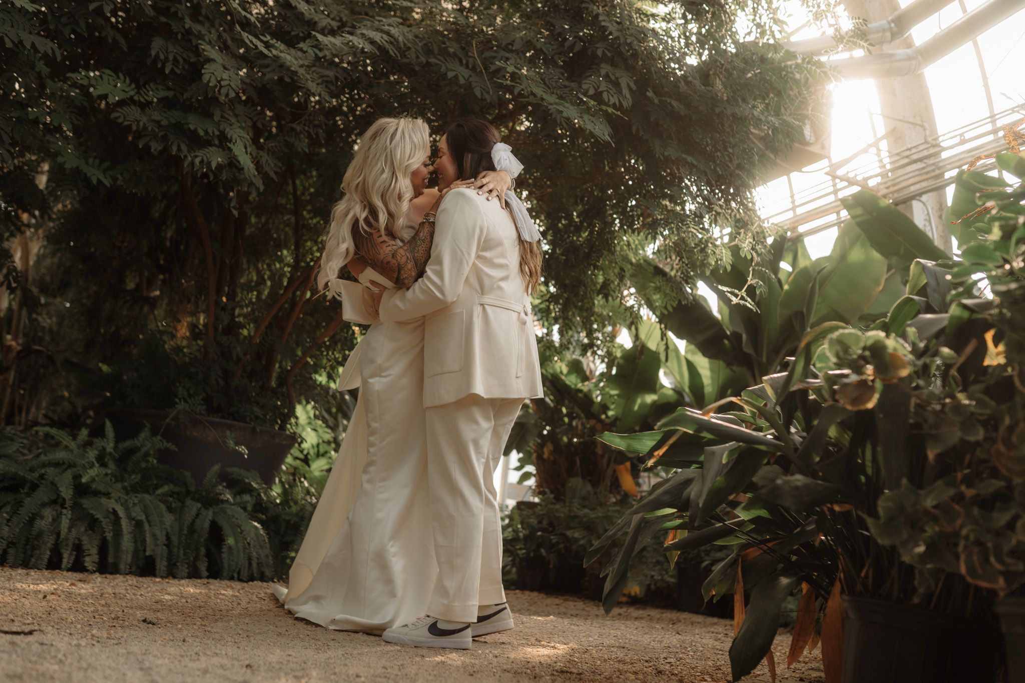 Romantic garden photoshoot with sunlight streaming through tropical foliage.