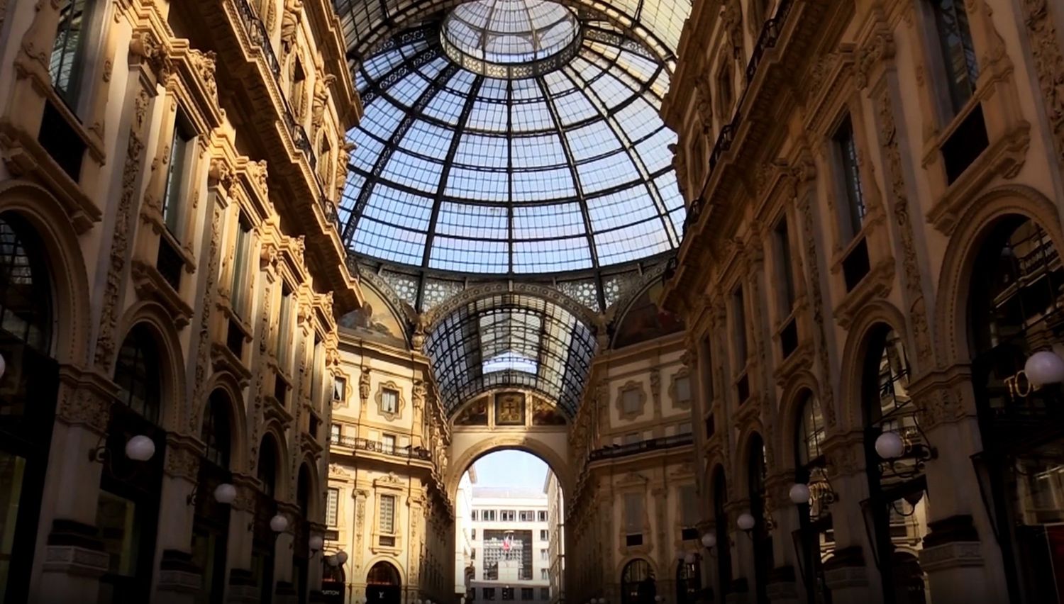 The historic Galleria Vittorio Emanuele II shopping arcade in Milan features an ornate glass dome and neoclassical architecture.