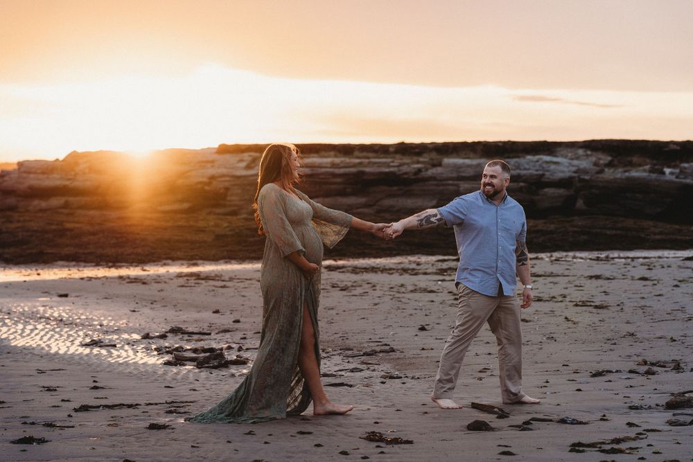 Romantic couple photoshoot at beach during golden sunset.
