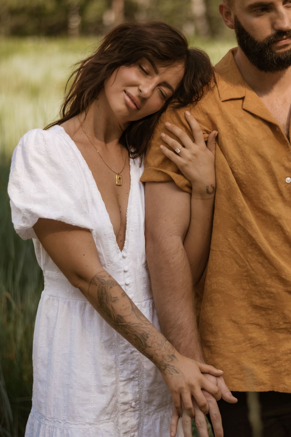 Intimate portrait session showing tender moments between two people in casual attire.