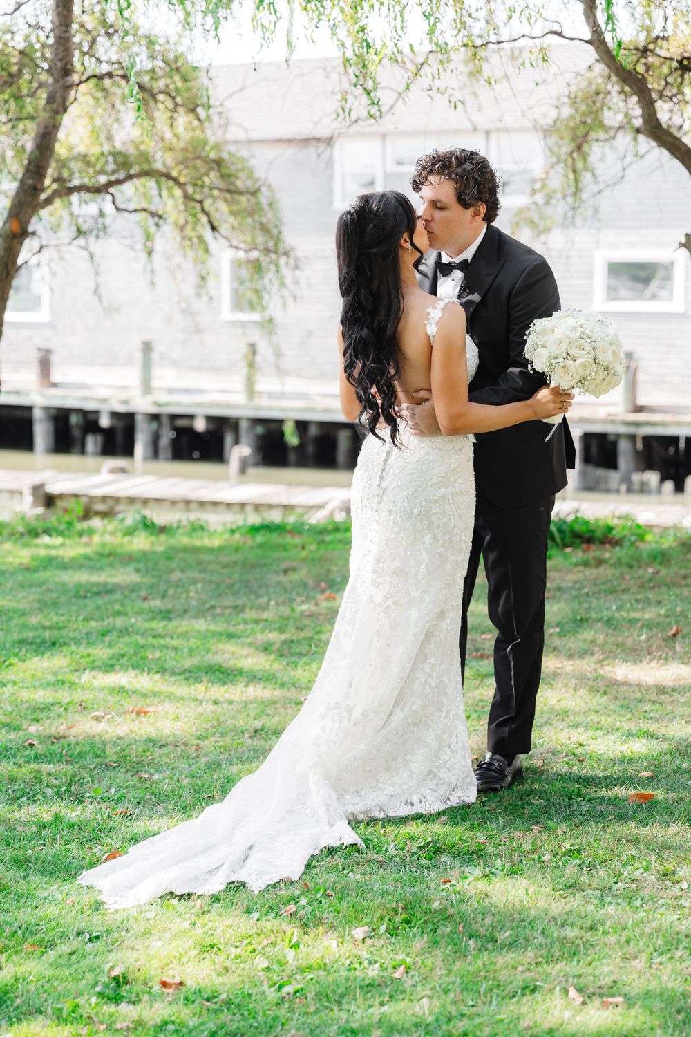 A romantic wedding photo sequence on a grassy lawn with trees in the background.